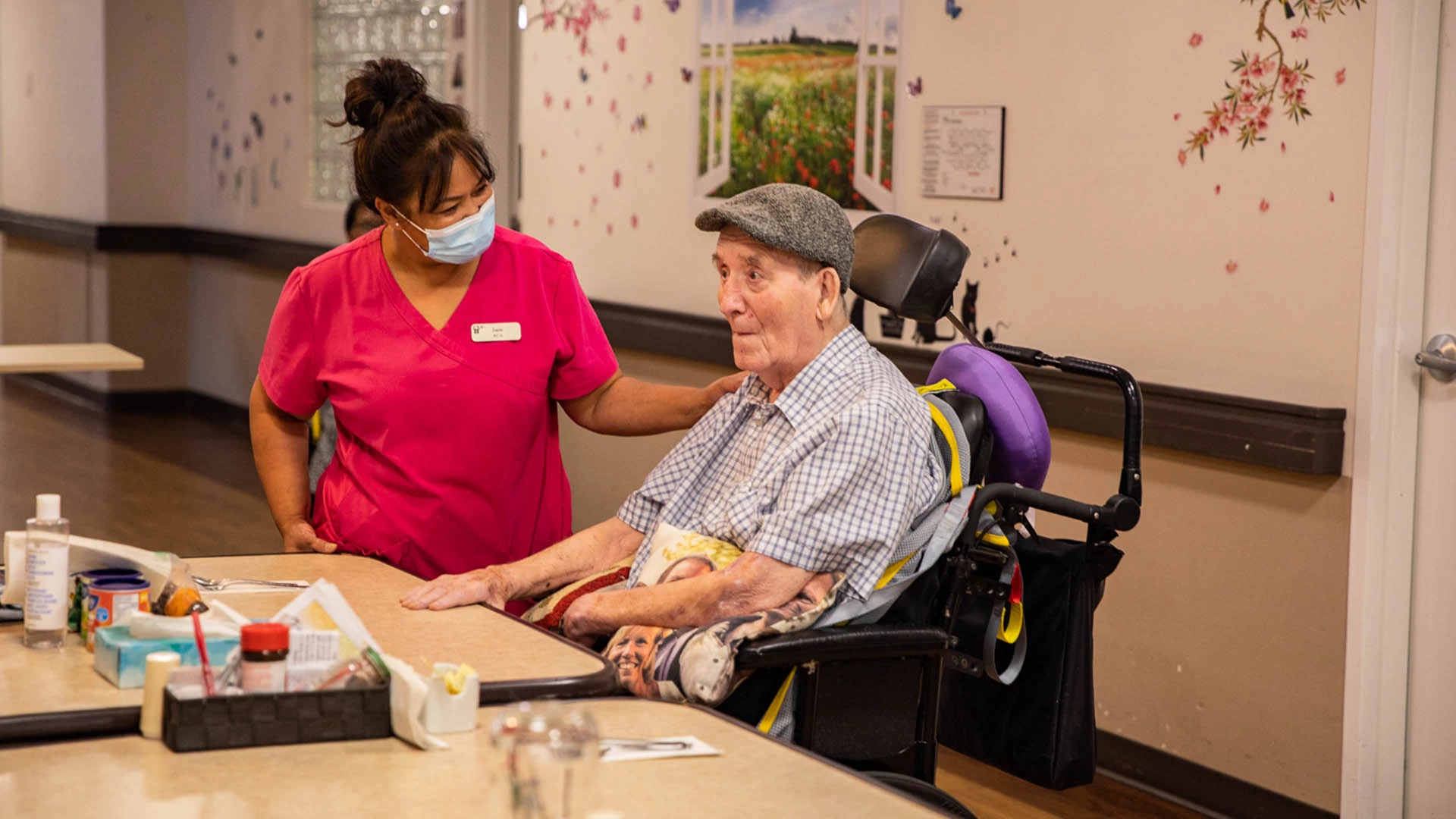 A health services provider comforting an elderly men at Westsyde's place